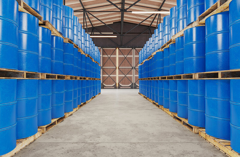 Blue barrels on wooden pallets in warehouse